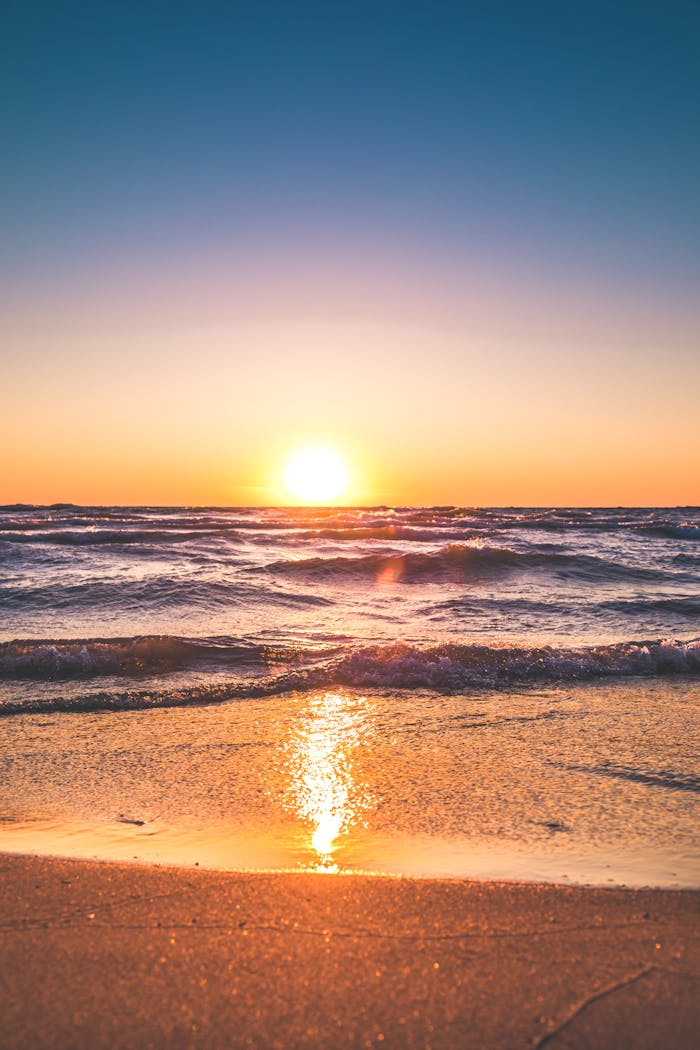 services-bg Experience the serene sunset over Ludington Beach with vibrant colors and tranquil waves.